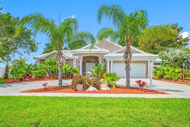 view of front of house with a garage and a front lawn