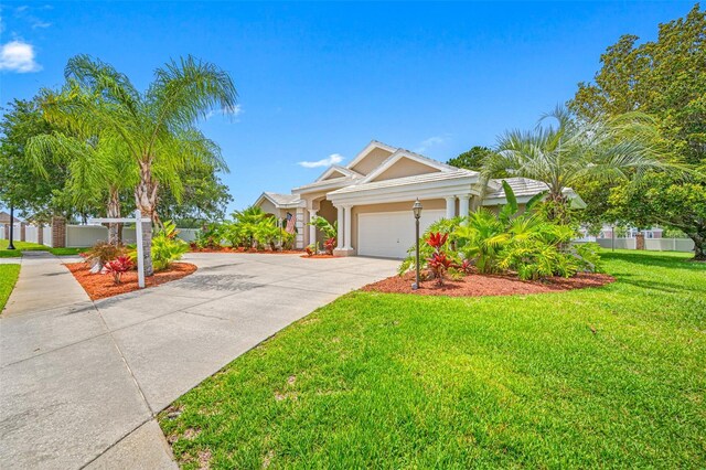 view of front of home with a front yard and a garage