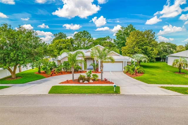 ranch-style house featuring a garage and a front lawn