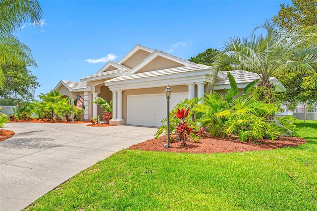 view of front of house with a garage and a front lawn