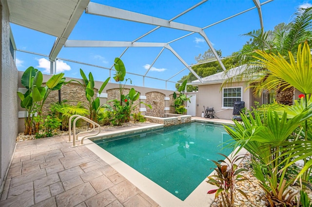 view of swimming pool with a lanai and a patio area