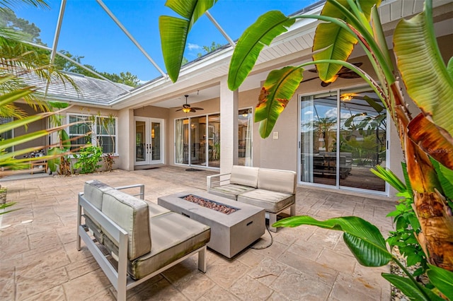 view of patio featuring an outdoor living space with a fire pit, ceiling fan, and french doors