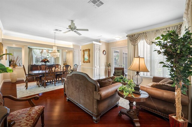 living room with ornamental molding, ceiling fan, and dark hardwood / wood-style floors