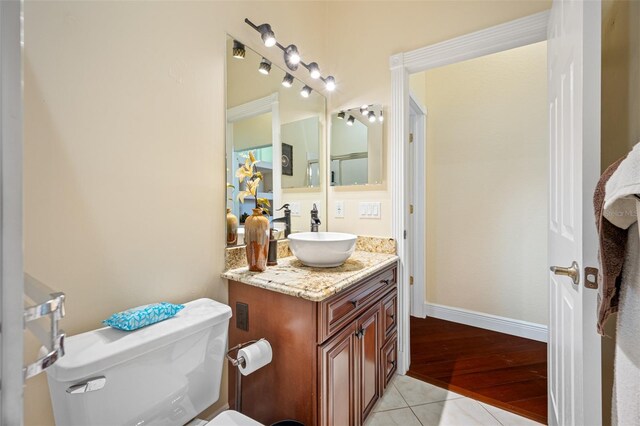 bathroom featuring tile floors, oversized vanity, and toilet