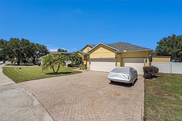 ranch-style house with a front lawn and a garage