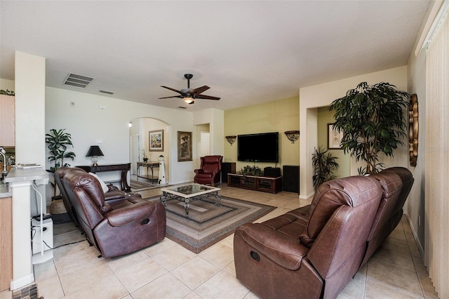 tiled living room with ceiling fan