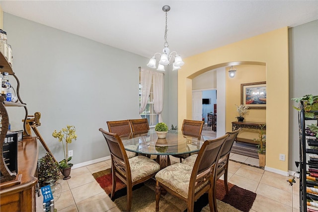 tiled dining space with a chandelier