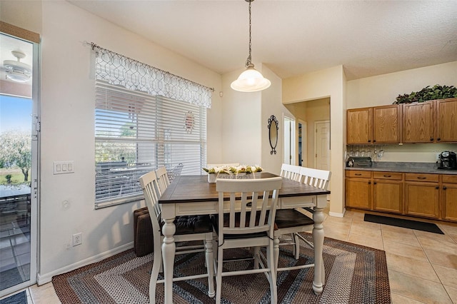 dining area featuring light tile floors