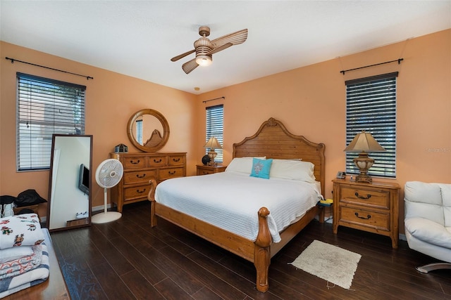 bedroom with ceiling fan and dark wood-type flooring