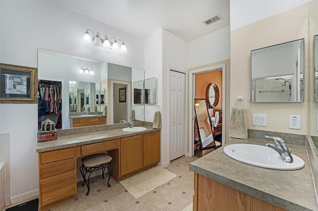 bathroom with vanity with extensive cabinet space and tile flooring