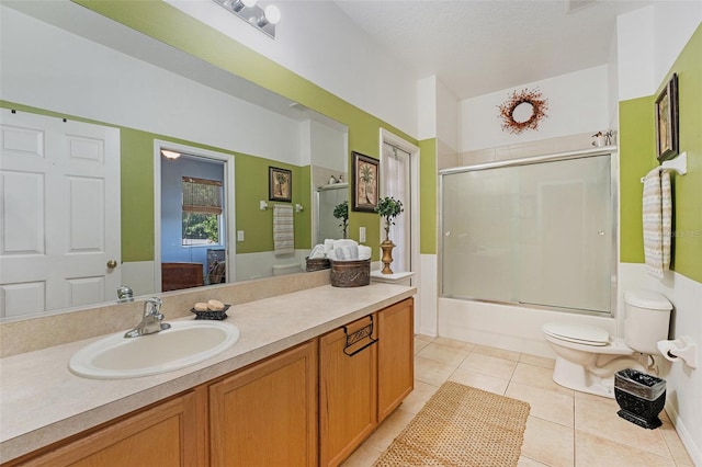 full bathroom featuring tile floors, a textured ceiling, bath / shower combo with glass door, toilet, and large vanity