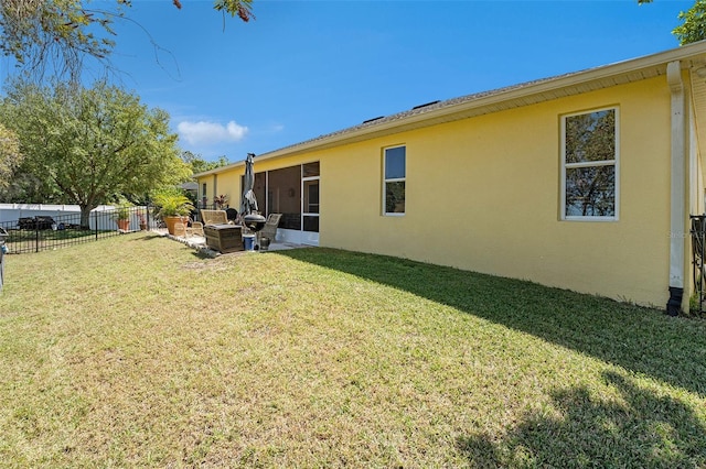 rear view of house featuring a patio and a yard