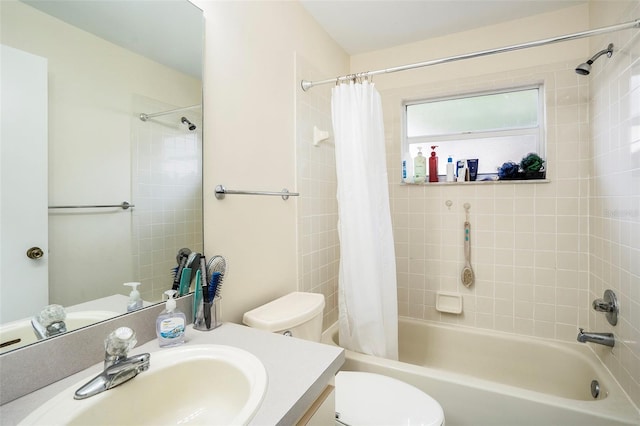 full bathroom featuring toilet, vanity with extensive cabinet space, and shower / bath combo