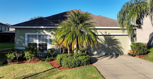 view of front of house with a front yard and a garage