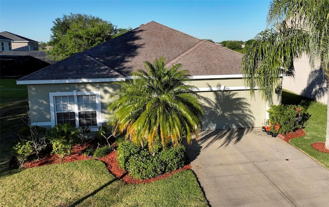 view of front of property with a front lawn and a garage