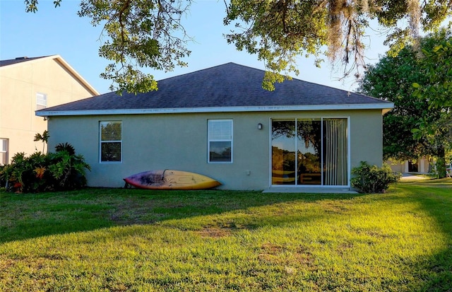 rear view of property featuring a yard