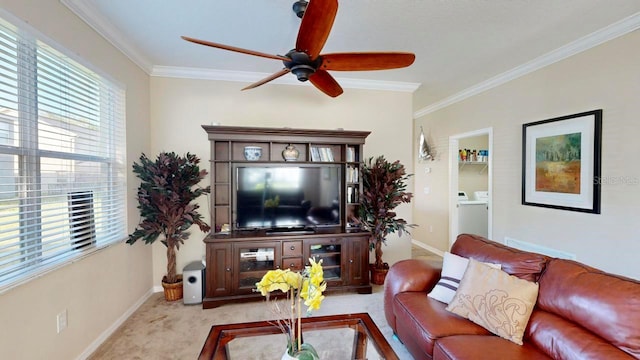 carpeted living room with washer / dryer, crown molding, and ceiling fan