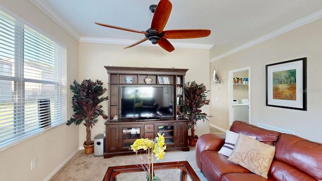 carpeted living room featuring washer / clothes dryer, ceiling fan, and crown molding