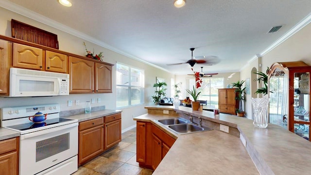 kitchen with light tile floors, ceiling fan, white appliances, crown molding, and sink