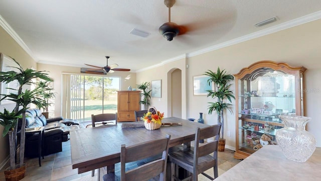 dining area featuring crown molding, ceiling fan, and light tile floors