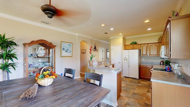 kitchen featuring light tile floors, ceiling fan, white appliances, and crown molding