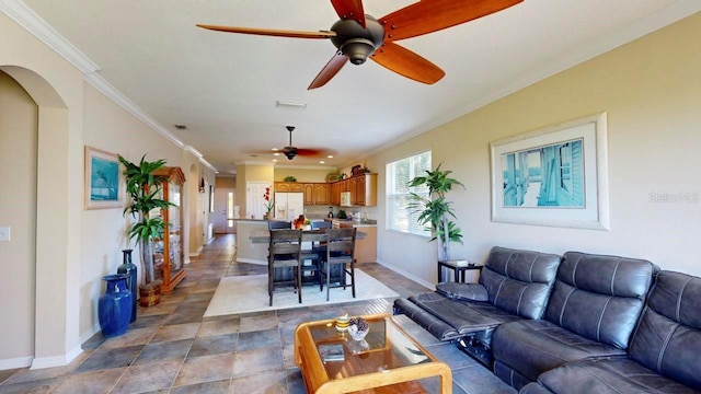 tiled living room with crown molding and ceiling fan