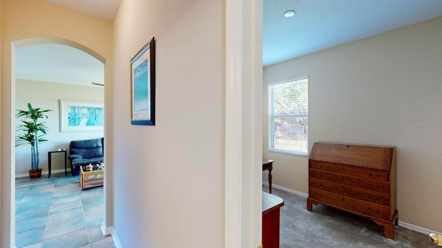 hallway with light colored carpet