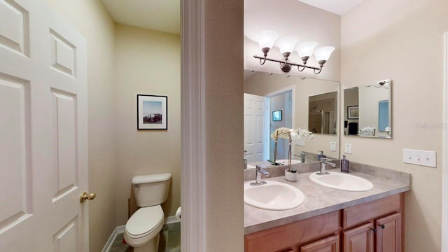 bathroom featuring toilet and vanity with extensive cabinet space