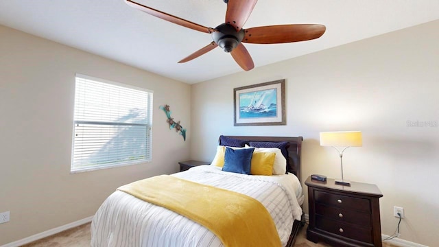 bedroom featuring light colored carpet and ceiling fan