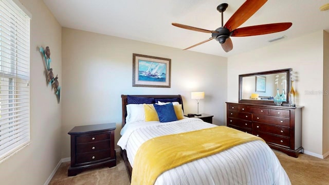 bedroom featuring light colored carpet and ceiling fan