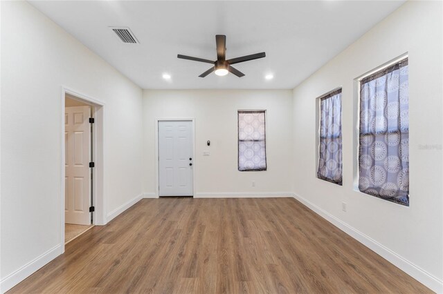 empty room featuring hardwood / wood-style floors and ceiling fan