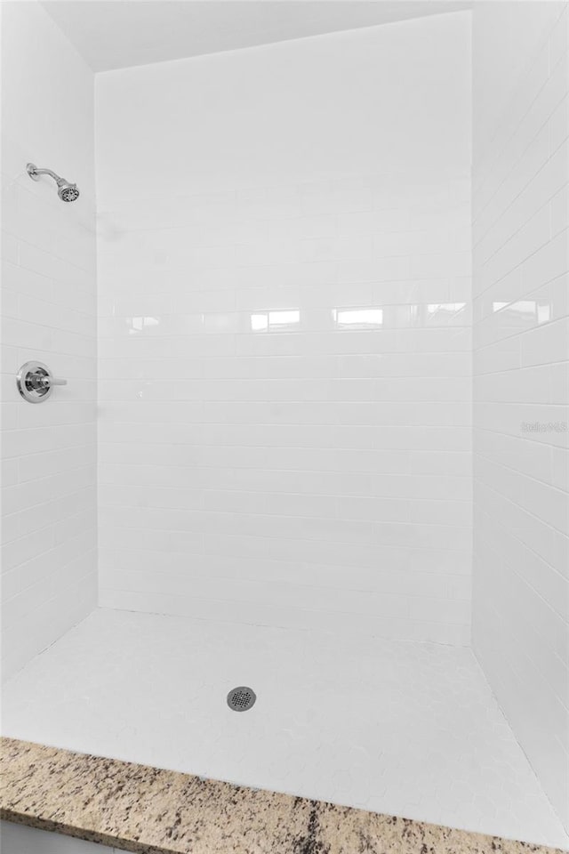 bathroom with tiled shower