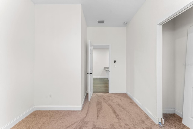 corridor with light colored carpet