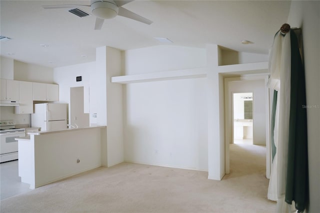 kitchen featuring ceiling fan, white appliances, white cabinetry, light colored carpet, and kitchen peninsula