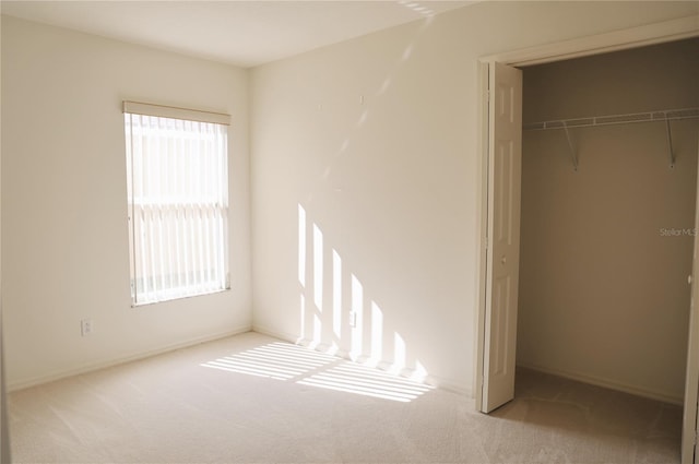 unfurnished bedroom with a closet and carpet flooring