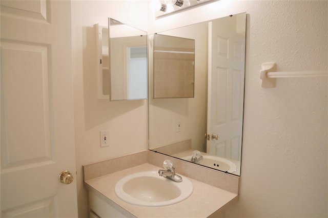 bathroom featuring vanity with extensive cabinet space