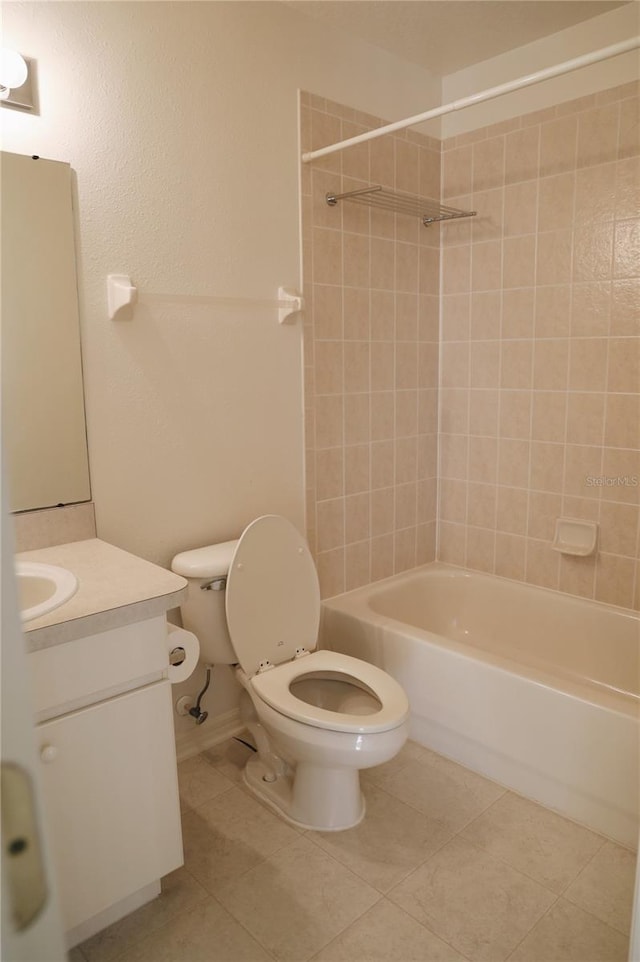 full bathroom featuring tiled shower / bath combo, tile flooring, vanity, and toilet