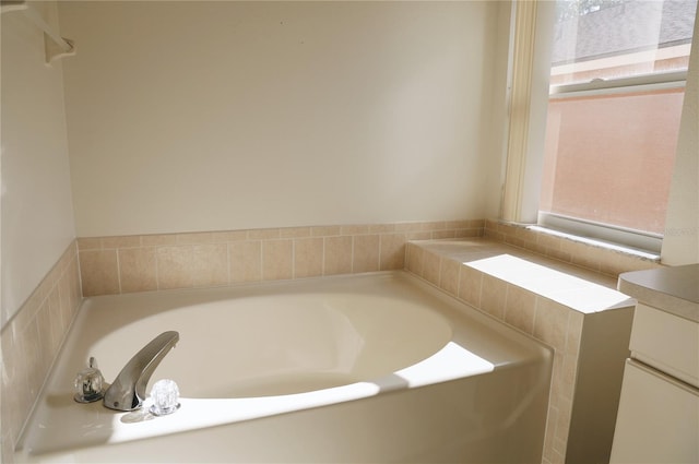 bathroom with a wealth of natural light and a bath