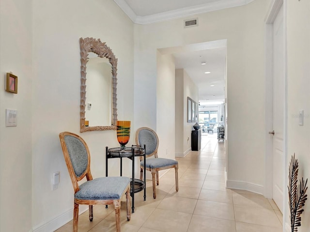 hall featuring crown molding and light tile floors