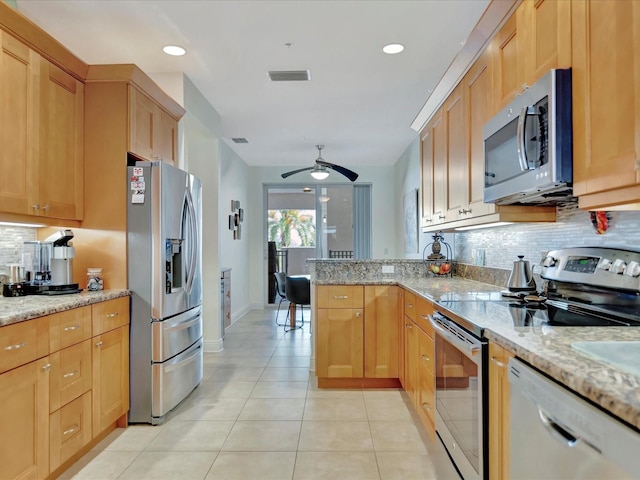 kitchen featuring backsplash, stainless steel appliances, ceiling fan, and light stone counters