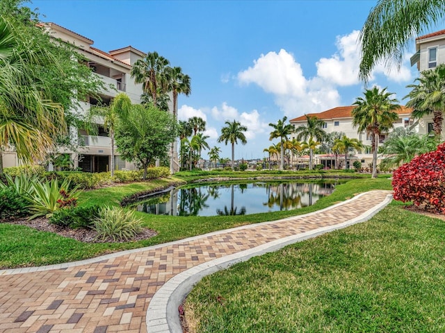 surrounding community featuring a water view and a yard