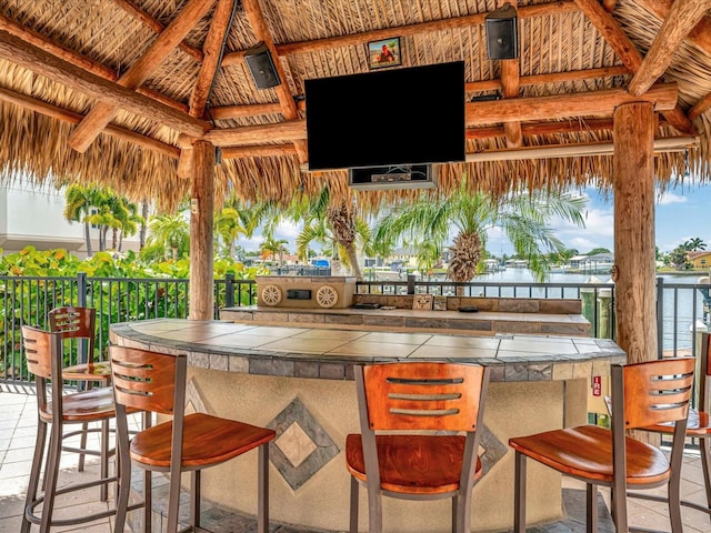 view of patio / terrace featuring a bar and a gazebo