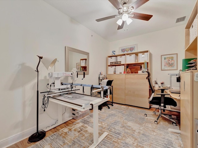 office space featuring ceiling fan and light wood-type flooring