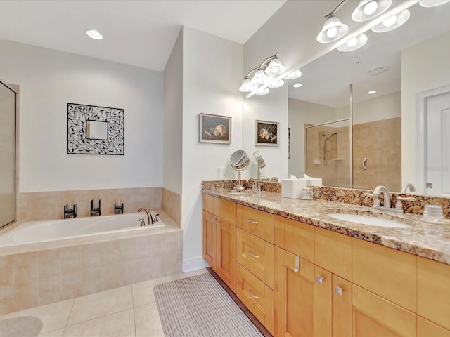 bathroom with tile floors, independent shower and bath, and double vanity