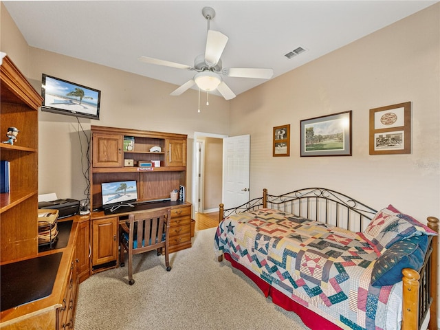 bedroom with light carpet, ceiling fan, and visible vents