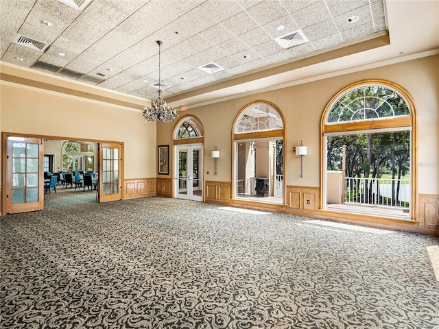 interior space with french doors, wainscoting, and visible vents