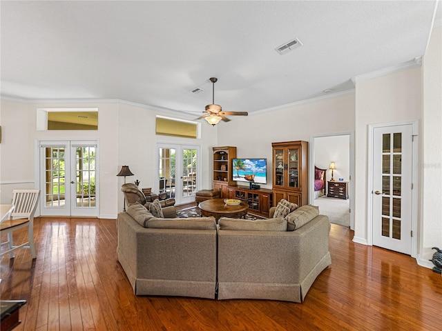 living room featuring ceiling fan, french doors, hardwood / wood-style flooring, and ornamental molding