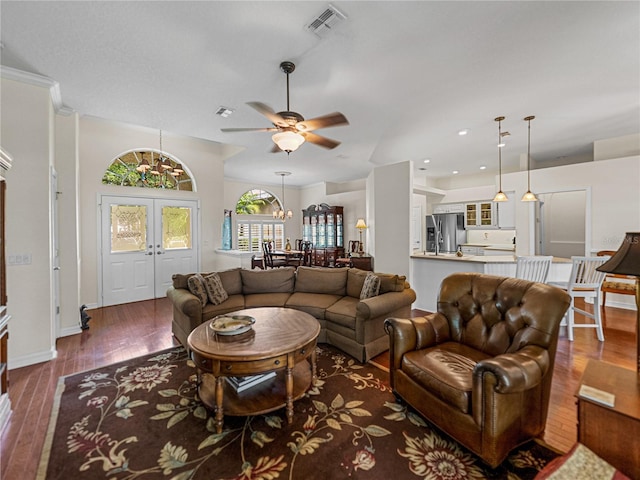 living room with french doors, visible vents, dark wood finished floors, and baseboards