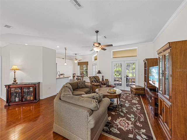 living area with visible vents, ornamental molding, dark wood-style flooring, and french doors