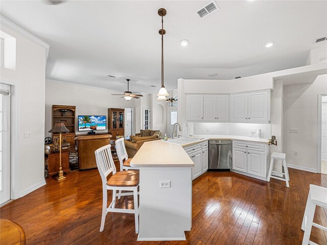 kitchen with pendant lighting, dark hardwood / wood-style floors, ceiling fan, sink, and stainless steel dishwasher